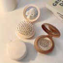 1pc Mini Portable Folding Hair Brush with Integrated Mirror, Scalp Massage Comb with Air Cushion Base for All Hair Types - Travel-Friendly Hair Care Accessory